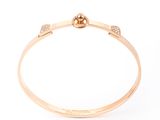 a gold bang bracelet with diamonds on a white background