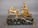 a statue of a man and a woman on a horse drawn carriage