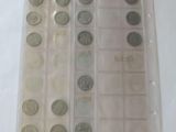 a lot of coins that are in a plastic case