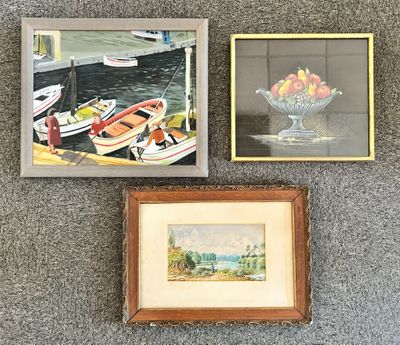 two framed paintings of boats and a bowl of fruit sit on a carpet