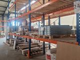 a large warehouse filled with lots of shelves and pallets