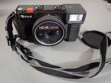 a camera that is sitting on a table with a camera strap around it