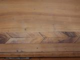 a close up of a wooden table with two arrows on it