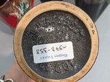a person holding a bowl that has a tag on it