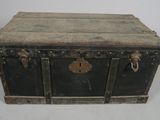 an old black trunk with metal handles on a white background