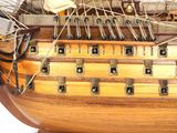 a wooden model of a ship on display on a table
