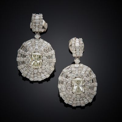 a pair of diamond and white gold earrings