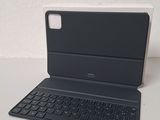 an open laptop computer sitting on top of a table next to a keyboard