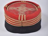 two red and black boxes with gold trims on a white surface