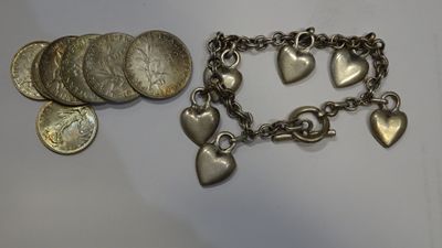 a close up of a bracelet with coins and a coin on it