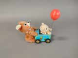 two teddy bears in a toy car with a red balloon