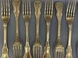 a lot of forks and spoons that are on the table