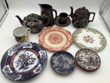 many different plates and cups on the table