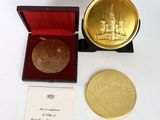 an image of a gold medal in a red box with a card