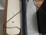 a laptop computer sitting on top of a desk next to a cell phone