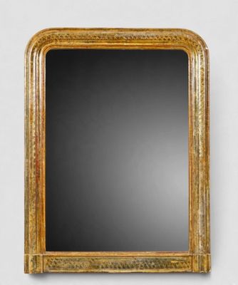 un miroir à cadre doré accroché à un mur blanc sur fond noir