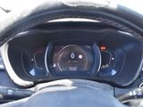 dashboard of a car with a steering wheel and a digital display