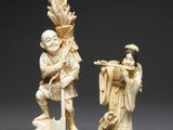 two carved ivory figurines of a man and a woman