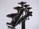 a picture of a metal candle holder on a pole