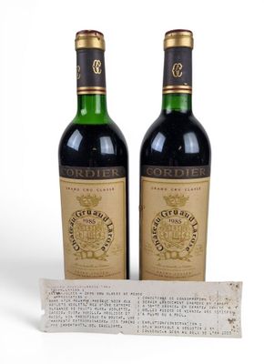 two bottles of wine sitting next to each other on top of a table
