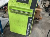 a green refrigerator that is sitting in a garage