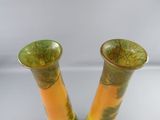 two vases that are sitting on a table