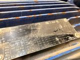 a metal plaque on the back of a blue car