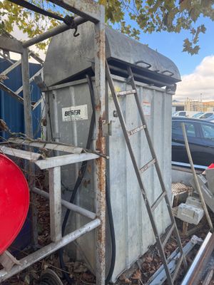 a red barrel sitting in the back of a truck
