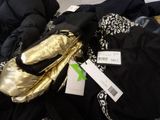 a pile of clothes and a pair of shoes on the floor