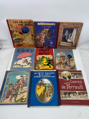 several children ' s books are lined up on a white surface