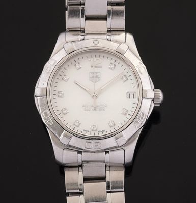 a close up of a watch on a black surface