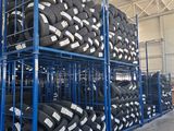 many tires stacked on a rack in a warehouse