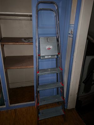 a ladder leaning against a blue door in a room
