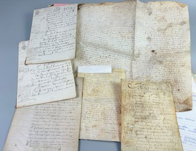 several old papers are sitting on top of each other on a table