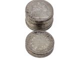 several coins are stacked on top of each other on a white surface