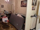 a living room with a couch and a refrigerator in it