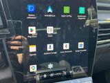 an image of a car dashboard with a tablet in the center