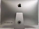 a silver apple computer monitor sitting on a white table