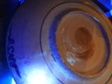 a blue light shining on a white plate on a stove