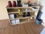 a wooden shelf with a bunch of items on top of it