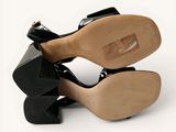 a pair of black shoes that are on top of each other
