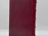 a red book sitting on top of a white surface