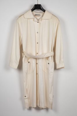 an image of a white trench coat hanging on a hanger