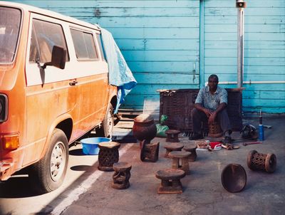 a man that is sitting in front of a van
