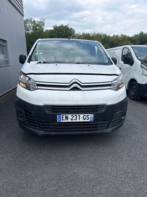 the white van is parked in the parking lot next to other cars