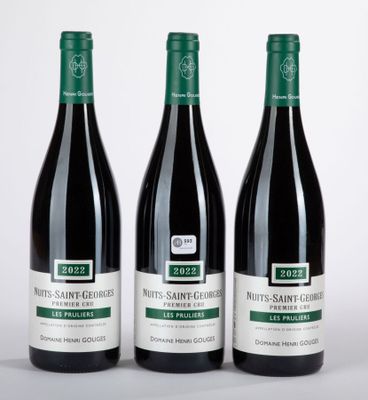 trois bouteilles de vin posées sur une table l'une à côté de l'autre