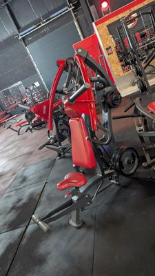 rows of red and black gym equipment in a large gym