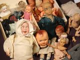 a box full of dolls and dolls sitting on a table