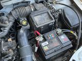 a car engine with a car battery in it