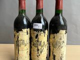 three bottles of wine sitting on top of a table next to each other